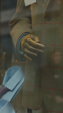 Vertical-Video-Close-Up-Of-Window-Display-In-Gents-Tailors-Shop-On-Avery-Row-In-Mayfair-London-UK